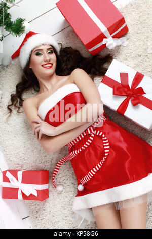 Happy young woman lying on the floor with chrismas gift box Stock Photo