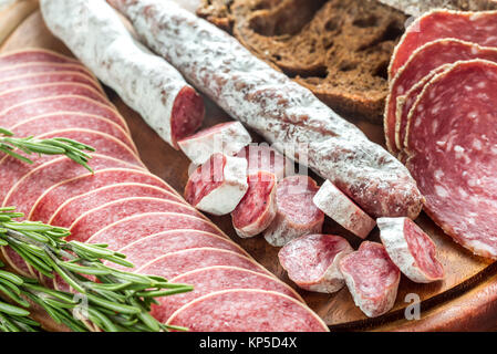 Different kinds of salami with dark-rye bread Stock Photo