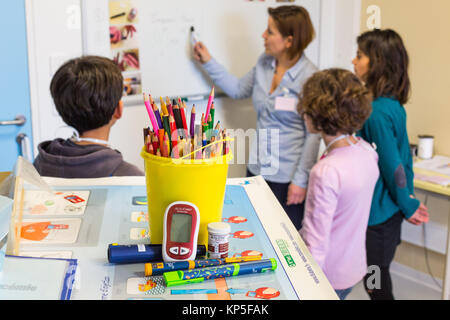 Diabetic children participating in a therapeutic education workshop animated by a nurse. Pediatric department of Angouleme hospital, France. Stock Photo