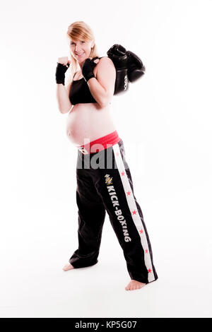 Schwangere Frau mit Boxhandschuhen - pregnant woman boxing Stock Photo