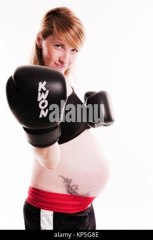 Schwangere Frau mit Boxhandschuhen - pregnant woman boxing Stock Photo
