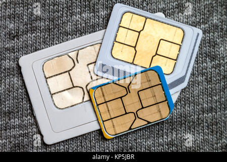 Set of mini, micro and nano simcard. Isolated on grey cloth texture background Stock Photo