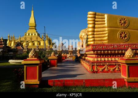 Giant gold reclining sleeping Buddha statue near Wat That Luang temple,Vientiane,Laos,Southeast Asia.