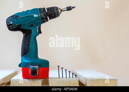 Electric cordless screwdriver and some screws close-up Stock Photo