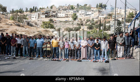 Jerusalem, Israel, October 29, 2010: Palestinians pray on Friday on the streets of  trebled residential district of Silwan in the centre of Jerusalem,