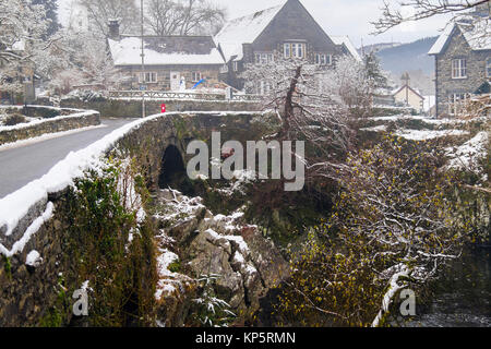 Pont-y-Pair old bridge circa 1470 over Afon Llugwy River in Snowdonia village with snow in winter 2017. Betws-y-Coed, Conwy, North Wales, UK Stock Photo