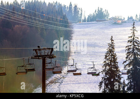 Ski lift with empty seats over the snow mountain in ski resort Stock Photo