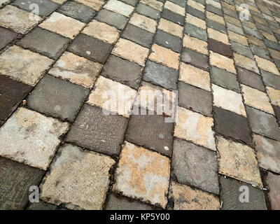 Pavement made from old grey concrete tiles Stock Photo