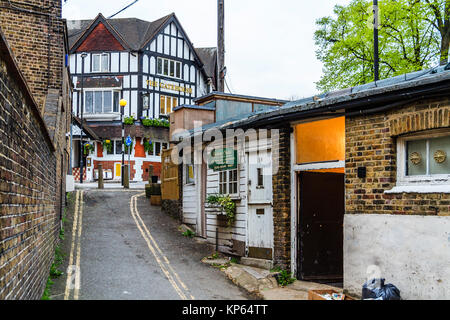 The narrow alley between Pond Square and West Hill, location of Julian Child clock restoration, Highagte Village, London, UK, prior to redevelopment Stock Photo