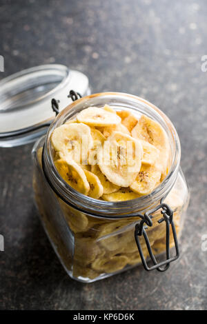 Dried banana chips in jar. Stock Photo