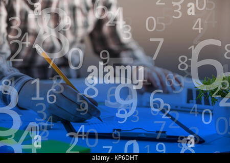 Businessman holding a pen is working with graph documents. Stock market chart and finger pointing on tablet in office. Numerical designed computer bac Stock Photo