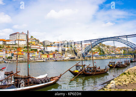 General view of Oporto, Portugal. Are visible the D. Luis bridge, the Douro river and a few boats that used to transport the barrels of Port wine. Stock Photo