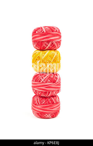Four sewing threads on white background. Red and yellow thread Stock Photo