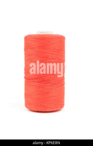 Orange spool of thread on white background Stock Photo