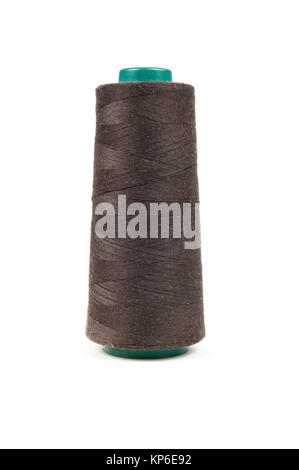Big dark brown spool of thread on white background Stock Photo