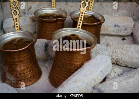 preparing coffee in pots on hot coals Stock Photo