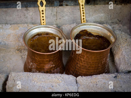 preparing coffee in pots on hot coals Stock Photo