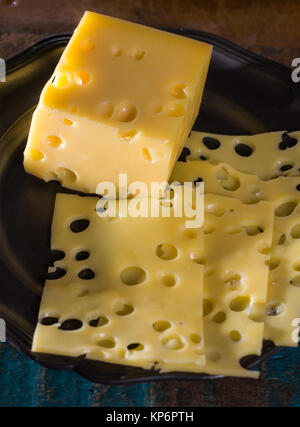 Yellow medium-hard mild Swiss cheese Emmental with cheese holes Stock Photo