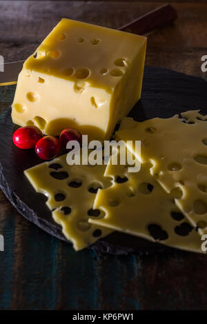 Yellow medium-hard mild Swiss cheese Emmental with cheese knife Stock Photo