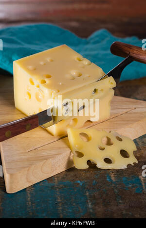 Yellow medium-hard mild Swiss cheese Emmental with cheese knife Stock Photo