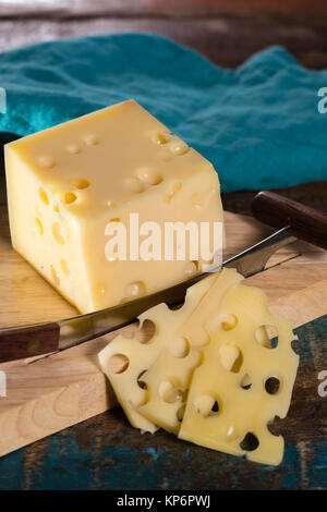 Yellow medium-hard mild Swiss cheese Emmental with cheese knife Stock Photo