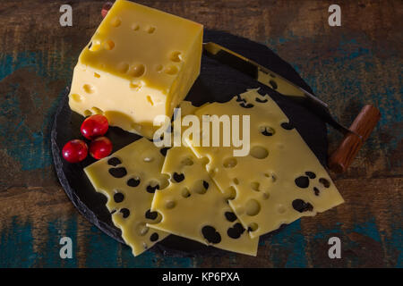 Yellow medium-hard mild Swiss cheese Emmental with cheese knife Stock Photo