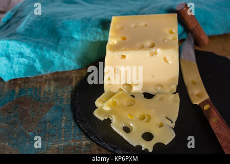 Yellow medium-hard mild Swiss cheese Emmental with cheese knife Stock Photo