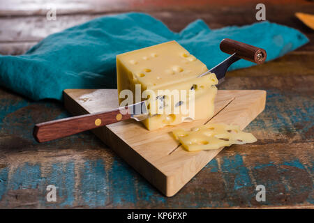 Yellow medium-hard mild Swiss cheese Emmental with cheese knife Stock Photo