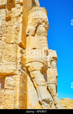 The side view of Lamassu (Assyrian deity) statues, decorating the All Nations Gate (Xerxes Gate) in Persepolis archaeological site, Iran. Stock Photo