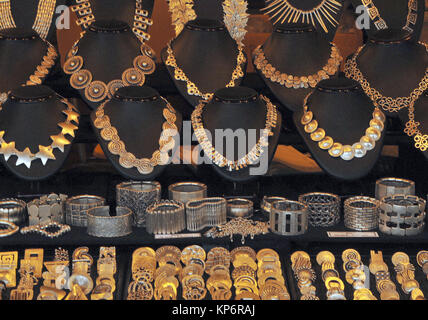 A selection of handmade jewellery for sale at a stall on a market at Hayes galleria near London Bridge in central London. Bespoke jewellery for sale. Stock Photo