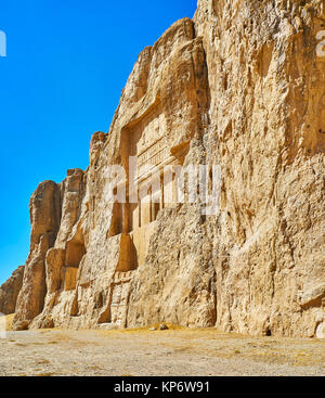 The walk along the huge cliff, famous for the ancient mausoleums, cut in it, Naqsh-e Rustam Necropolis, Iran. Stock Photo