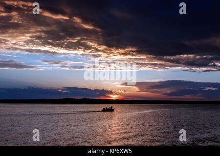Fishing boat on the lake in Oklahoma at sunset.