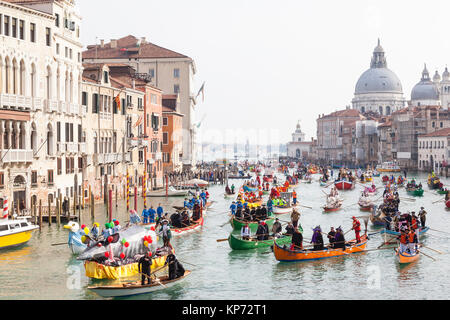 The Regata for the locals at the start of the Venice Carnival, Venice, Veneto, Italy with boats full of people in colorful costumes on the Grand Canal Stock Photo