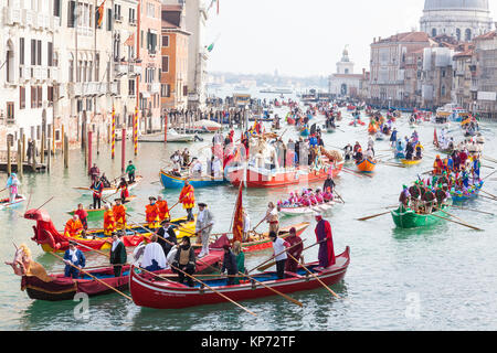 The Carnival regatta on the Grand Canal during the 2017 Venice Carnival, Italy with boats full of local Venetians in colorful costumes Stock Photo