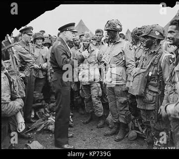 General Dwight D. Eisenhower gives the order of the Day.  'Full victory-nothing else' to paratroopers in England, just before they board their airplanes to participate in the first assault in the invasion of the continent of Europe.  06/06/1944 Stock Photo