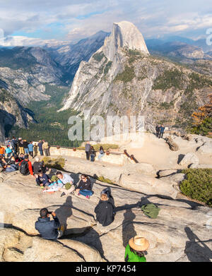 Half Dome Yosemite view from Glacier Point Overlook with people family taking pictures. Yosemite National Park California USA Stock Photo