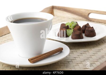 cup of coffee and chocolates in a tray Stock Photo