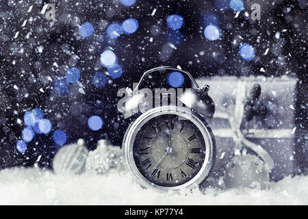 Silver antique alarm clock on blue blurred background. New Year concept, copy space Stock Photo
