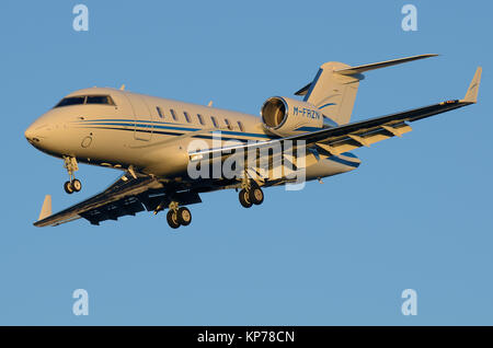 Private Canadair CL-600-2B16 Challenger 605 M-FRZN landing at London Heathrow Airport, UK. Used by Iceland Frozen Foods. Warmth from low winter sun Stock Photo