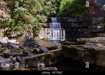 A stepped waterfall at Bowes In Teesdale in County Durham, on a bright sunny day. Stock Photo