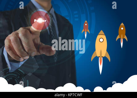 Businessman pressing virtual buttons on screen concept with rocket and white cloudy. Stock Photo