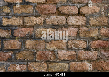 Very old pale red brick wall as background or wallpaper. Brick texture and pattern Stock Photo