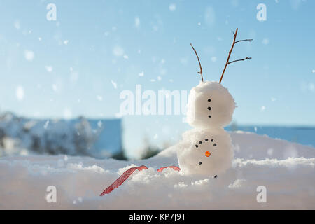 Cheerful snowman doing a handstand in the snow - landscape version Stock Photo