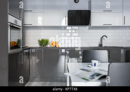 High gloss white and gray cabinets in modern kitchen Stock Photo