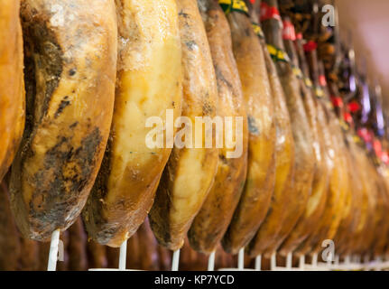 Line of cured iberico ham hanging legs Stock Photo