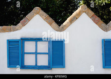 wooden window on the white wall with weathered wooden shutter Stock Photo