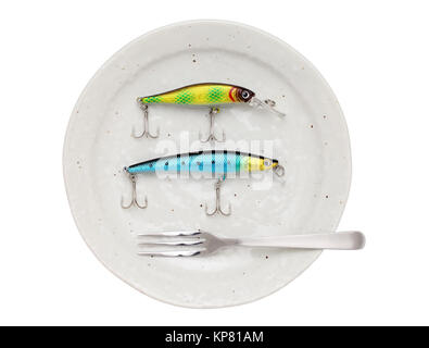 Plastic fishing lure on plate Stock Photo