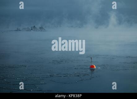 Red buoy in the freezing Baltic Sea in Helsinki, Finland Stock Photo