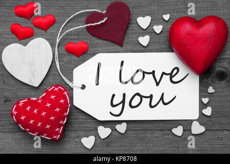 Label With Red Textile Hearts On Wooden Gray Background. English Text I Love You. Retro Or Vintage Style. Black And White Image With Colored Hot Spot. Stock Photo