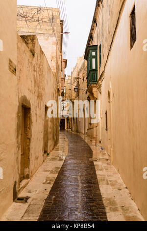Wet, narrow, cobbled streets in Victoria, Gozo, Malta following a heavy rain storm. Stock Photo